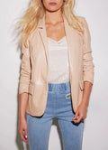 Nude blush leather open-front blazer with ruched sleeves worn with jeans