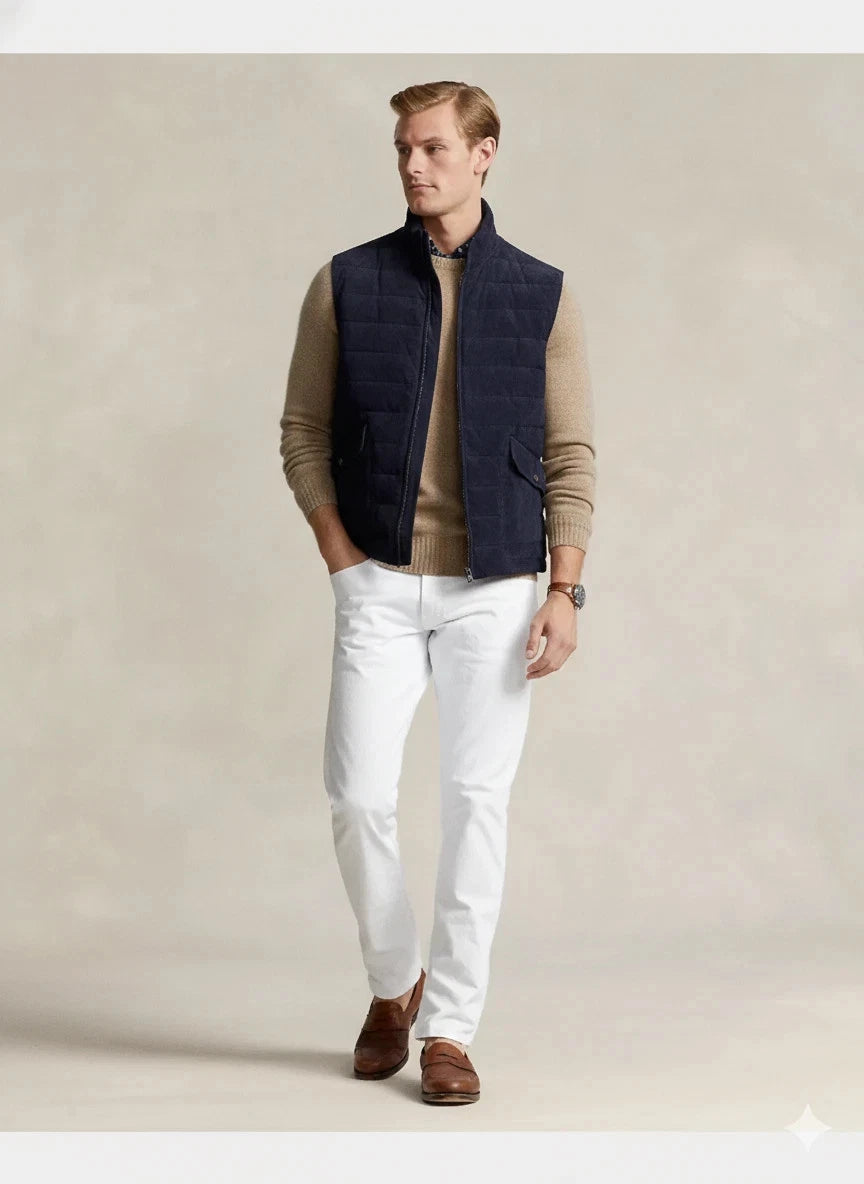 Front view of a navy quilted zip-front vest with a stand collar and two front pockets