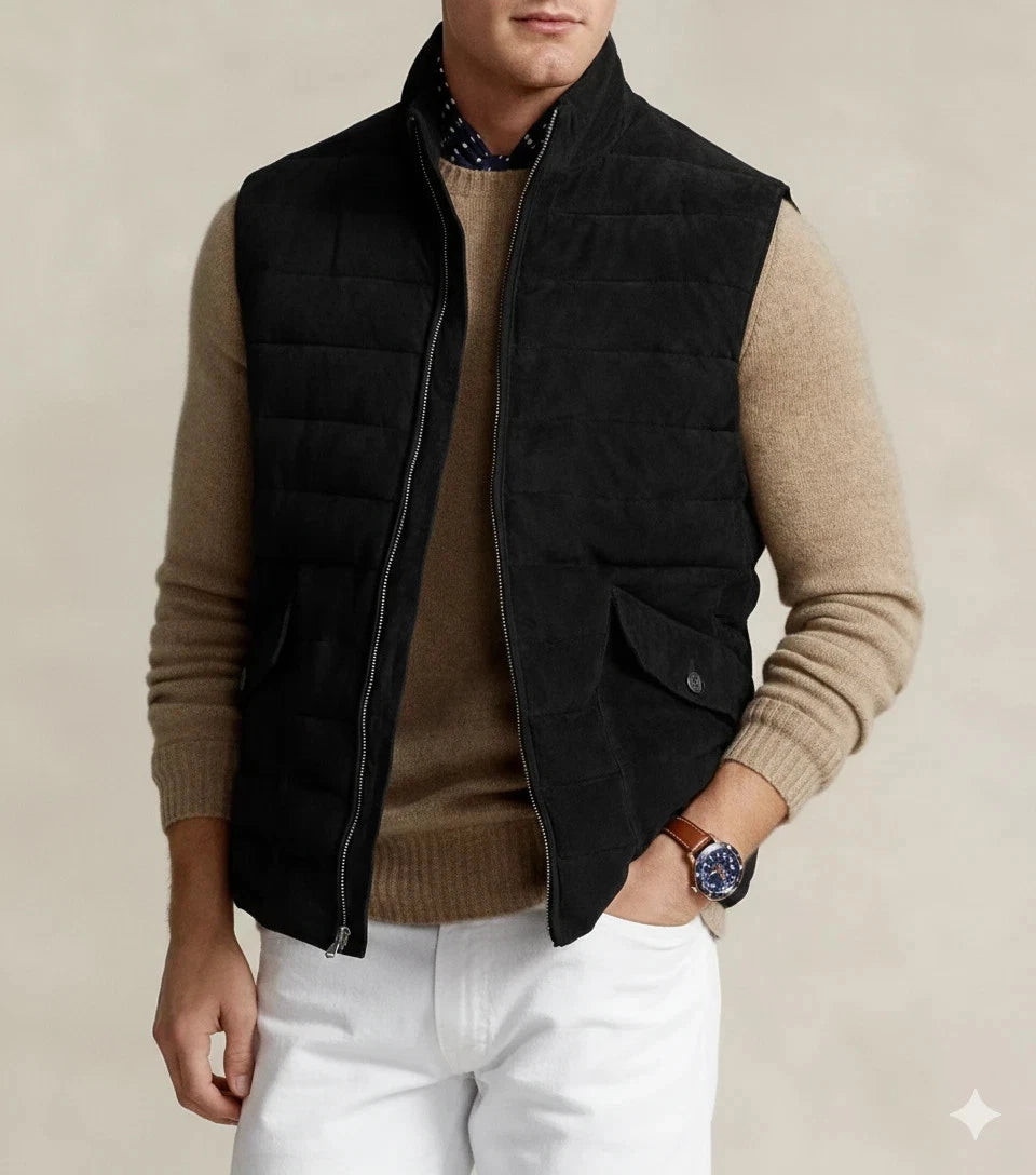 Man wearing a black quilted suede leather vest with stand-up collar and flap pockets, front view