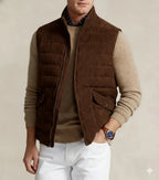 Man wearing a dark brown quilted suede leather vest with stand-up collar and flap pockets, front view