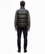 Back view of black horizontally quilted sleeveless puffer vest on model